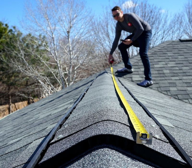 roof repair Professional contractor performing roof repair on residential home.